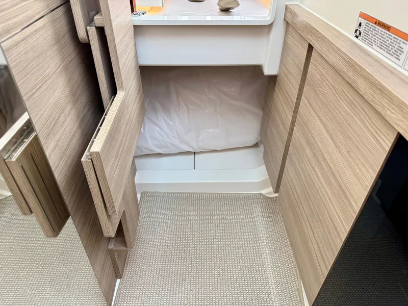Slide: The Image of Interior with wood paneling and carpet, showing a sleeping berth with pillows. - 38
