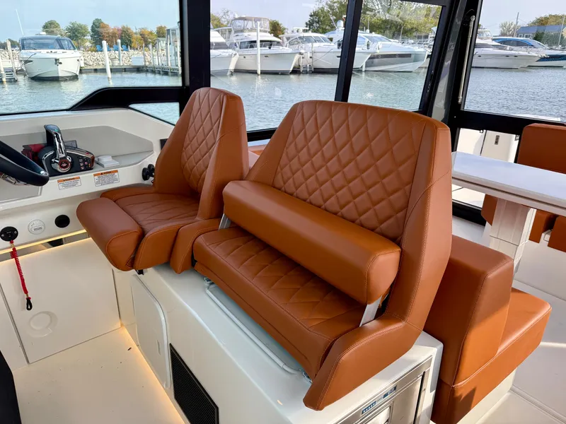 Slide: The Image of Interior of the Saxdor 400 GTC featuring sleek brown leather seats and a modern helm. - 14
