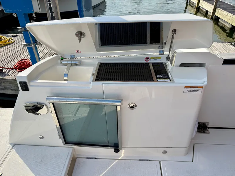 Slide: The Image of The 2027 Saxdor 400 GTC features a modern outdoor kitchen with a grill and storage. - 9
