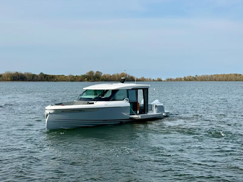 Slide: The Image of 2027 Saxdor 400 GTC on calm water with a wooded shoreline in the background. - 1