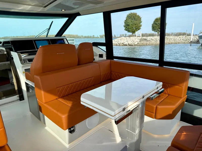 Slide: The Image of Interior of the Saxdor 400 GTC with orange seating and a white table. - 10