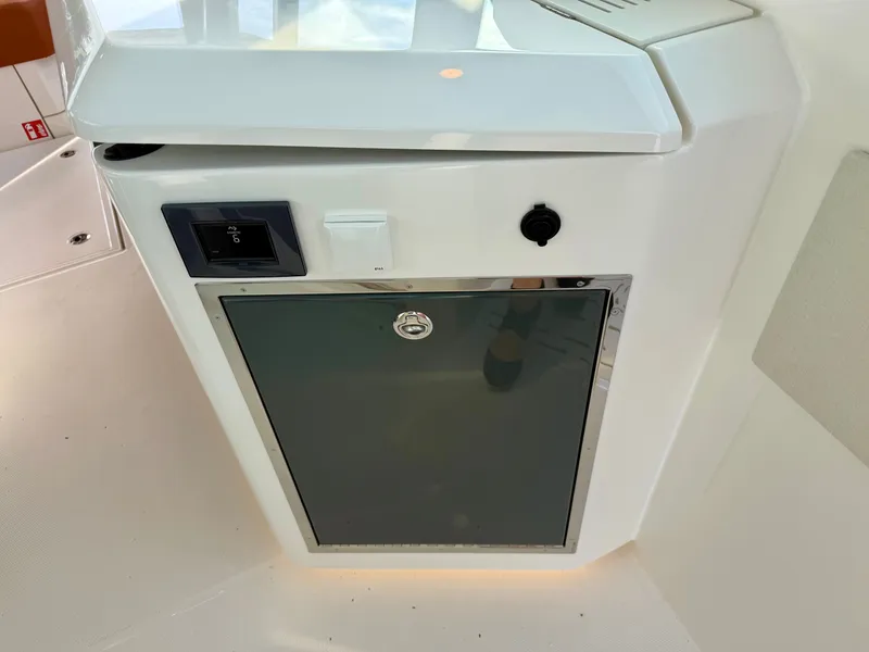 Slide: The Image of A modern refrigerator compartment on a Saxdor 400 GTC boat, featuring a sleek white surface. - 24