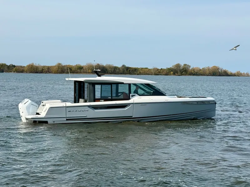 The Image of 2027 Saxdor 400 GTC on calm water, featuring a sleek design and enclosed cabin. - 0