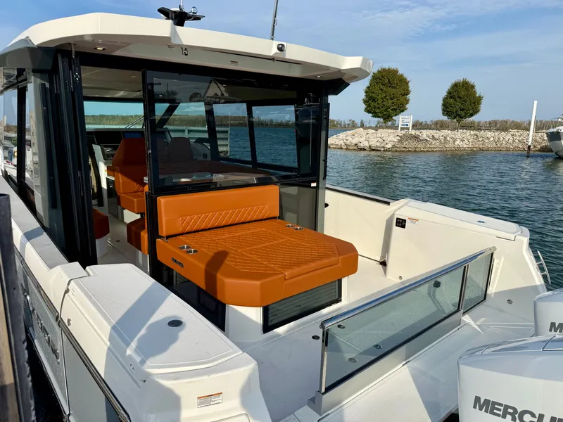 Slide: The Image of The image shows a modern Saxdor 400 GTC boat with orange seating by the water. - 8
