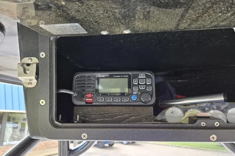 Slide: The Image of VHF marine radio installed in a 2021 NauticStar 231 Hybrid boat compartment. - 14