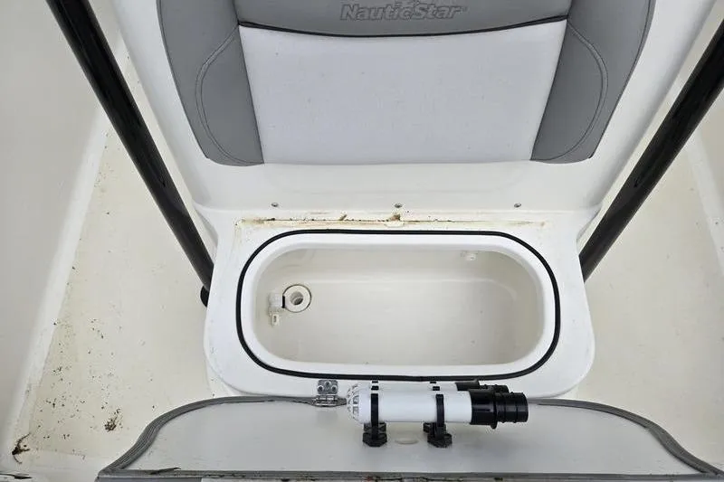 Slide: The Image of 2021 NauticStar 231 Hybrid boat storage compartment with gray seating and white interior. - 4