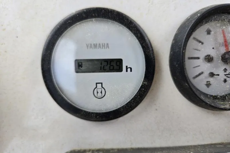 Slide: The Image of Yamaha engine hour meter showing 126.9 hours on NauticStar 231 Hybrid, 2021 model. - 5