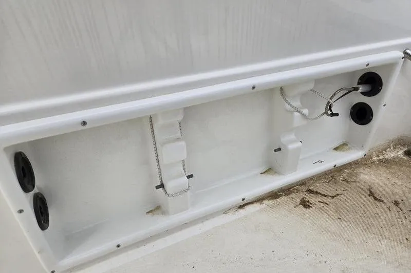 Slide: The Image of 2021 NauticStar 231 Hybrid boat interior detail with storage compartments and wiring. - 6