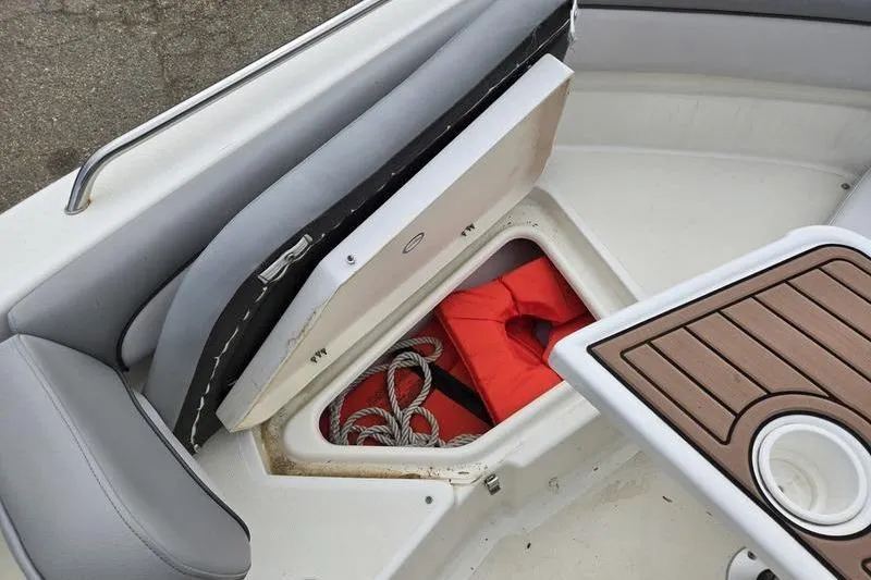 Slide: The Image of 2021 NauticStar 231 Hybrid boat storage with life jacket and ropes. - 9