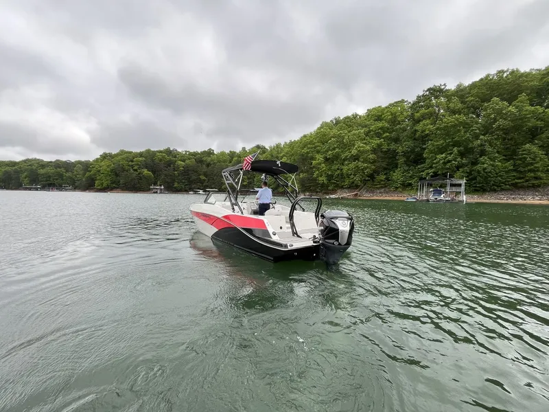 Slide: The Image of 2025 Starcraft SVX OB 230 DC OB boat on a calm lake. - 13
