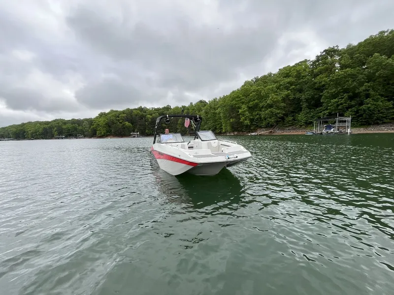 Slide: The Image of 2025 Starcraft SVX OB 230 DC OB on a tranquil lake. - 2
