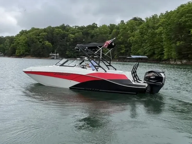 Slide: The Image of A modern Starcraft boat with red and black design cruising on a calm lake. - 4