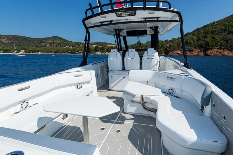 Slide: The Image of Manufacturer Provided Image: 2026 Wellcraft 38 T-Top boat with spacious seating, sleek design, and scenic ocean backdrop. - 3