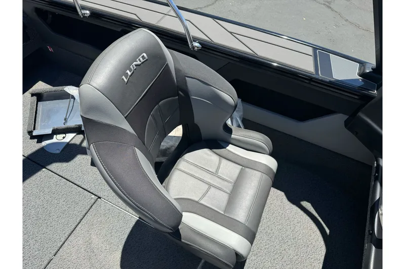 Slide: The Image of 2026 Lund 1875 Crossover XS boat seat, featuring sleek black and gray design. - 17