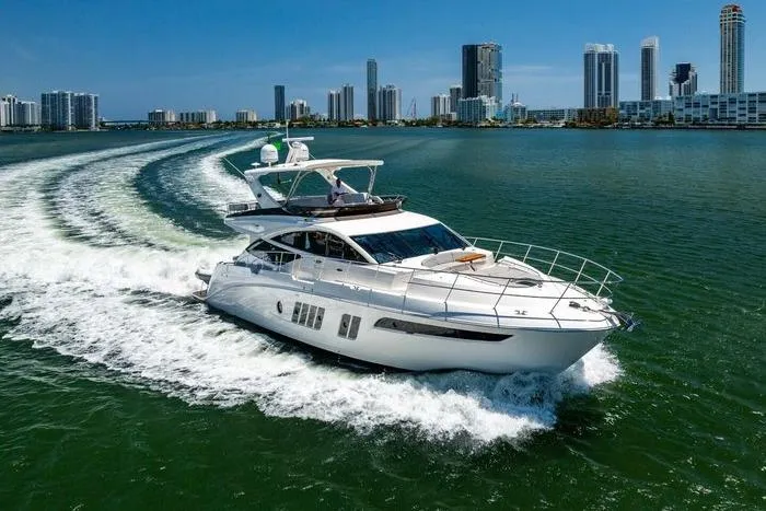 The Image of Luxurious 2016 Sea Ray L650 Fly yacht cruising near city skyline. - 0
