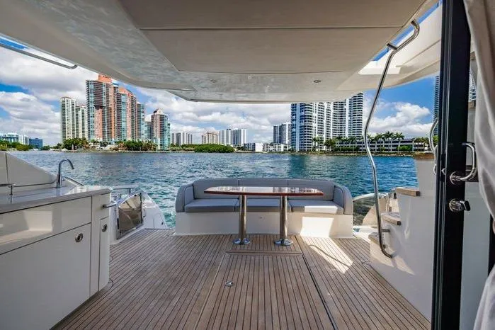 Slide: The Image of Luxurious 2016 Sea Ray L650 Fly yacht with scenic waterfront city view. - 6