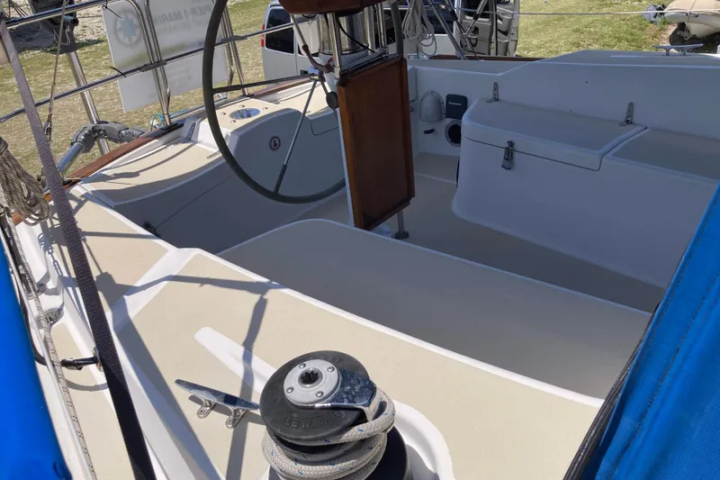 Slide: The Image of 1990 Tartan 372 sailboat cockpit with steering wheel and winch. - 10