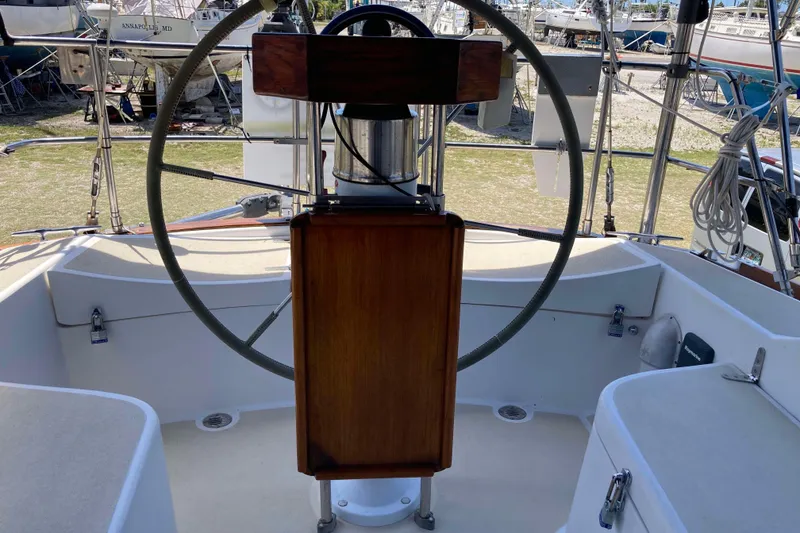 Slide: The Image of Cockpit of 1990 Tartan 372 sailboat with steering wheel and wooden panel. - 11