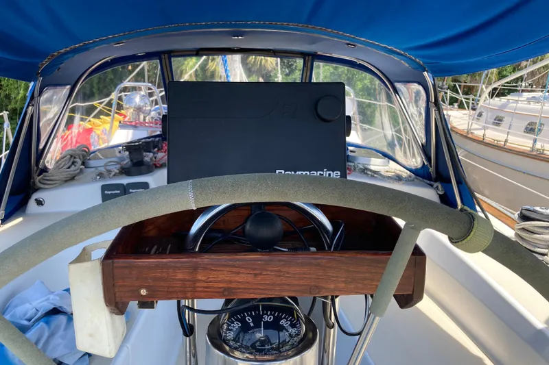 Slide: The Image of Cockpit of 1990 Tartan 372 sailboat with steering wheel and navigation equipment. - 12