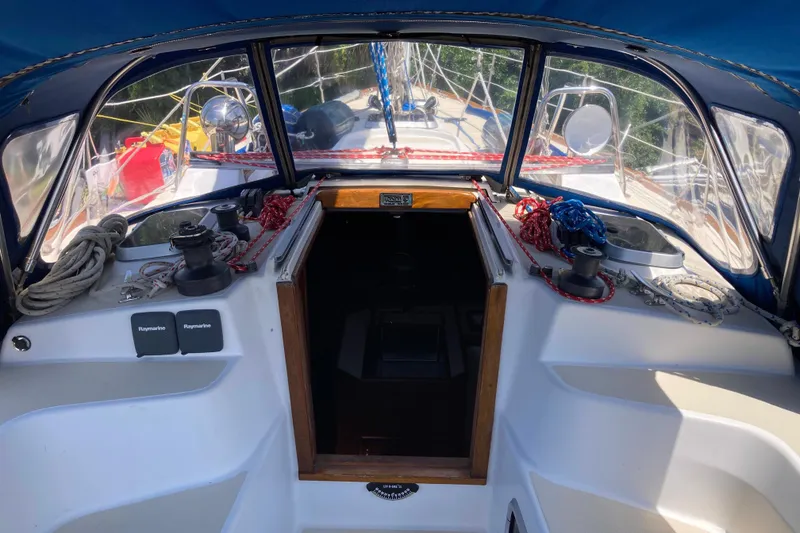 Slide: The Image of Cockpit view of a 1990 Tartan 372 sailboat with ropes and navigation equipment. - 13