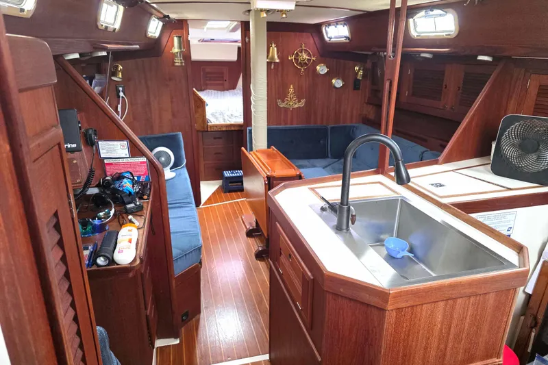 Slide: The Image of Interior of a 1990 Tartan 372 sailboat with wood finish and cozy seating area. - 19
