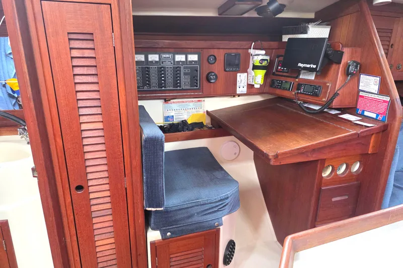 Slide: The Image of Navigation station of 1990 Tartan 372 sailboat with wooden cabinetry and marine electronics. - 21