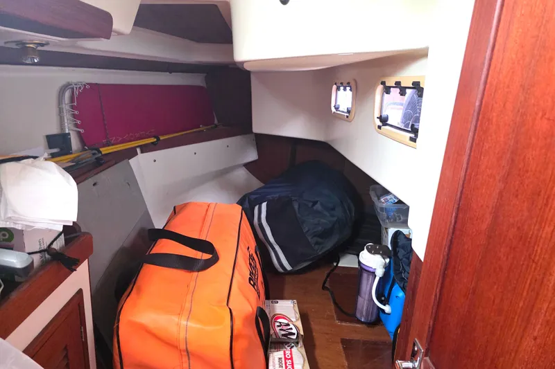Slide: The Image of Interior cabin of a 1990 Tartan 372 sailboat with storage bags and equipment. - 27