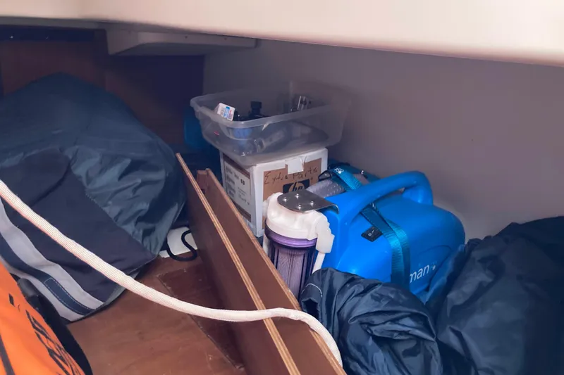 Slide: The Image of Storage area in a 1990 Tartan 372 sailboat with equipment and supplies. - 28