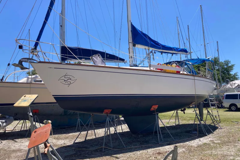 Slide: The Image of Sailboat on stands, Tartan 372 model from 1990, with blue covers and clear sky. - 3