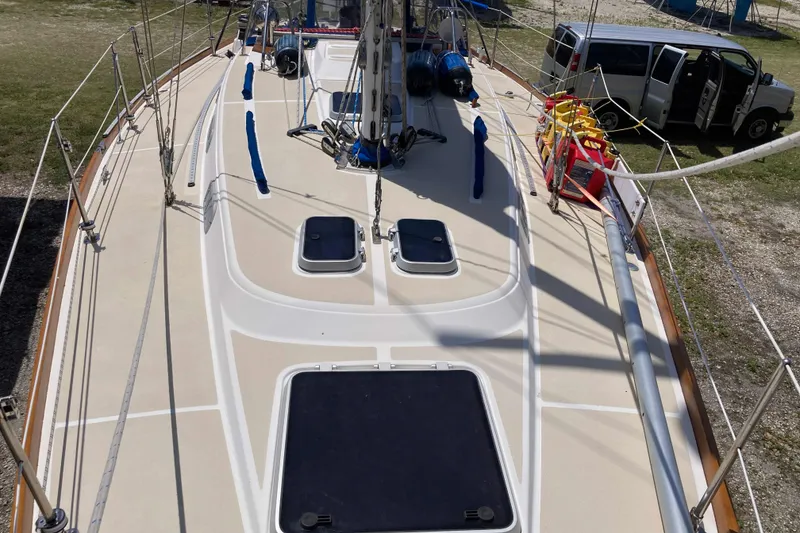 Slide: The Image of 1990 Tartan 372 sailboat deck with hatches, rigging, and safety equipment. - 5