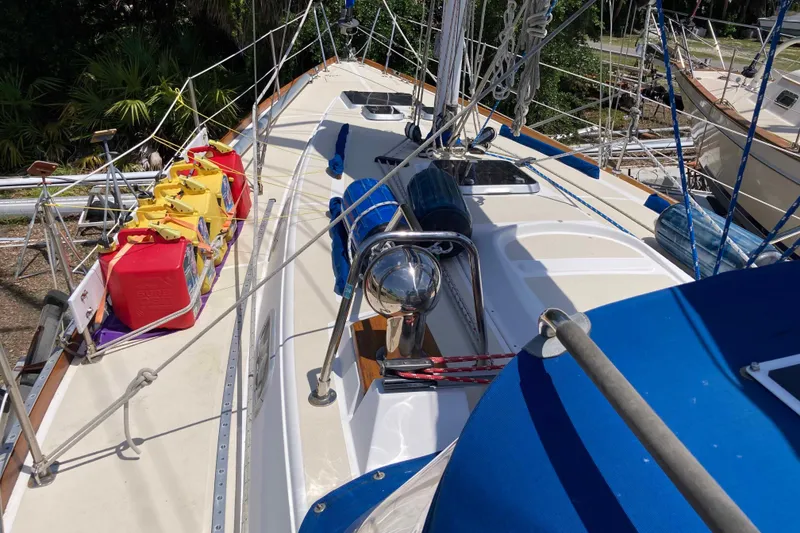 Slide: The Image of 1990 Tartan 372 sailboat deck with colorful fuel containers and rigging. - 6