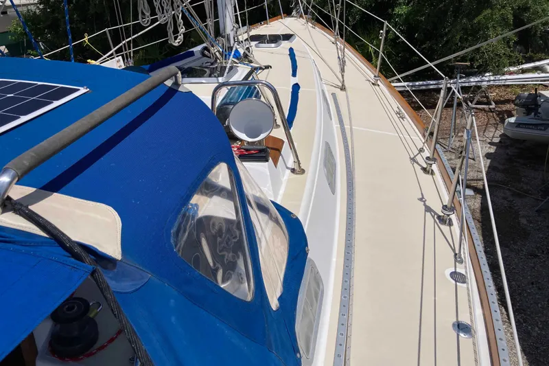 Slide: The Image of 1990 Tartan 372 sailboat deck with blue canopy and solar panel. - 7