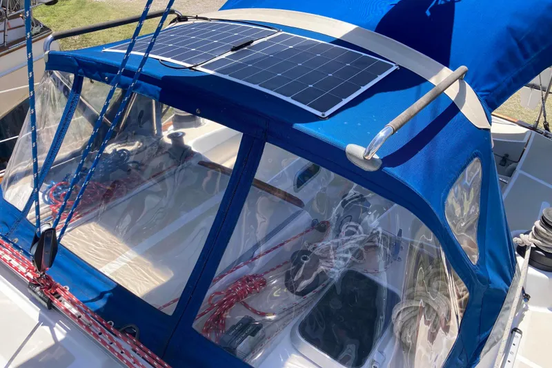 Slide: The Image of 1990 Tartan 372 sailboat with blue canopy and solar panel on deck. - 8