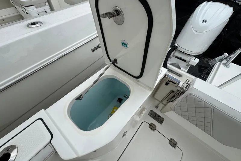 Slide: The Image of 2024 World Cat 260 DC-X boat with open storage compartment and visible engine. - 18