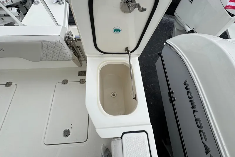 Slide: The Image of 2024 World Cat 260 DC-X boat interior with open storage compartment and visible branding. - 19
