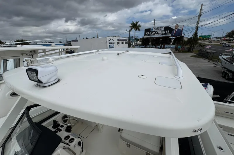 Slide: The Image of 2024 World Cat 260 DC-X boat roof with spotlight, under cloudy sky. - 22