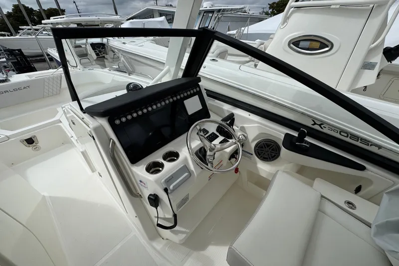 Slide: The Image of 2024 World Cat 260 DC-X boat cockpit with modern steering and control panel. - 26