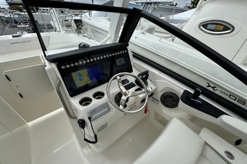 Slide: The Image of 2024 World Cat 260 DC-X boat cockpit with modern navigation system and steering wheel. - 29