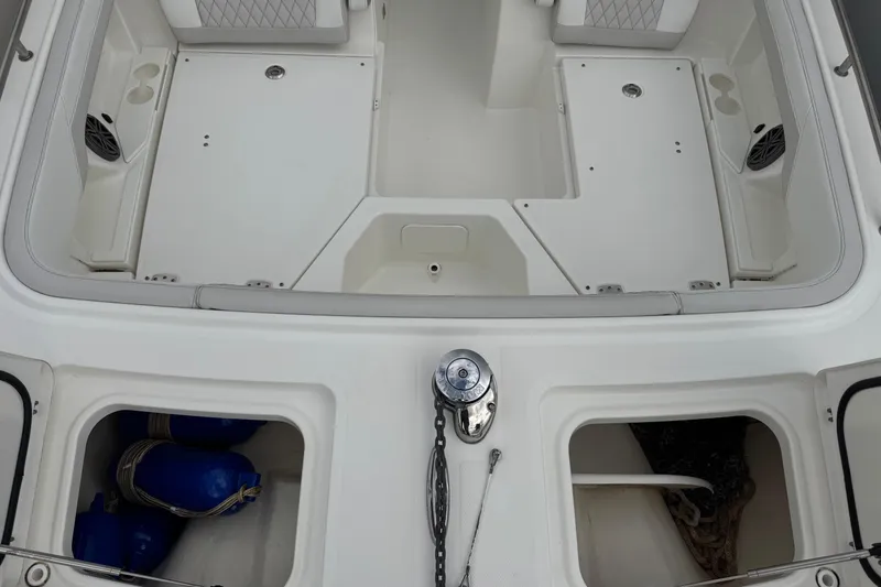 Slide: The Image of 2024 World Cat 260 DC-X boat interior with storage compartments and seating. - 34
