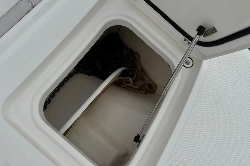 Slide: The Image of Open storage compartment on 2024 World Cat 260 DC-X boat, showing anchor chain and rope. - 35