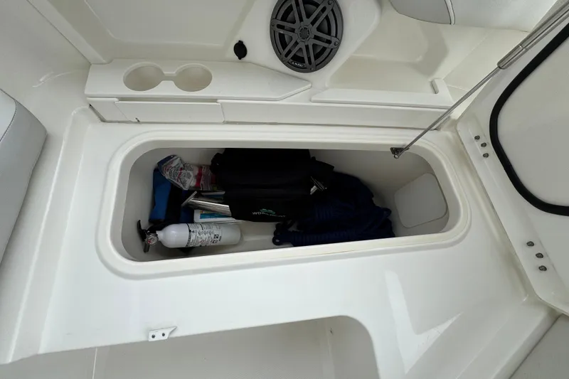 Slide: The Image of Storage compartment in 2024 World Cat 260 DC-X boat with safety equipment and accessories. - 39