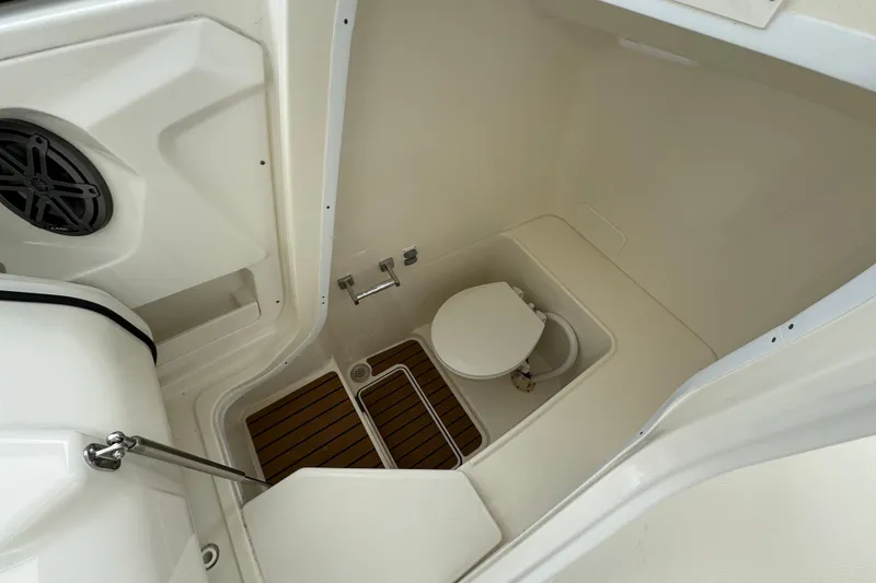 Slide: The Image of 2024 World Cat 260 DC-X boat interior with toilet and teak flooring. - 40