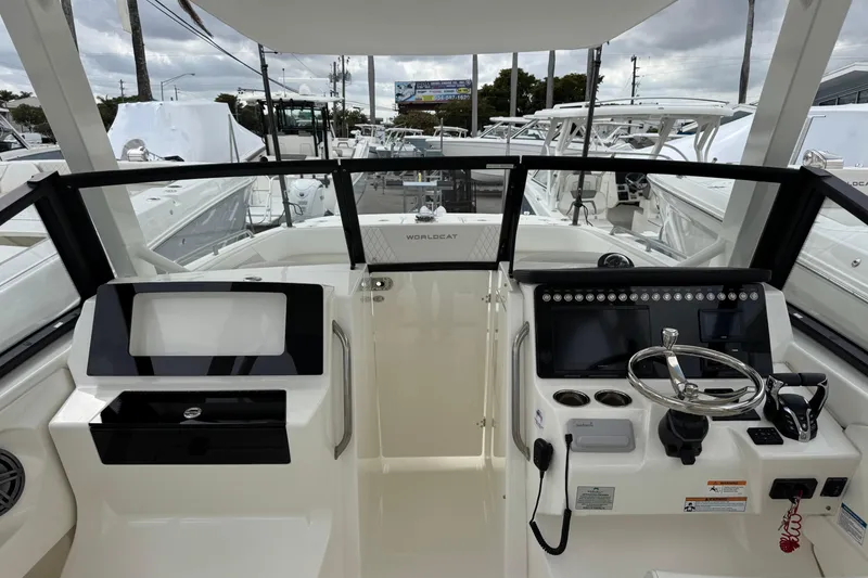 Slide: The Image of 2024 World Cat 260 DC-X boat cockpit with modern controls and steering wheel. - 48