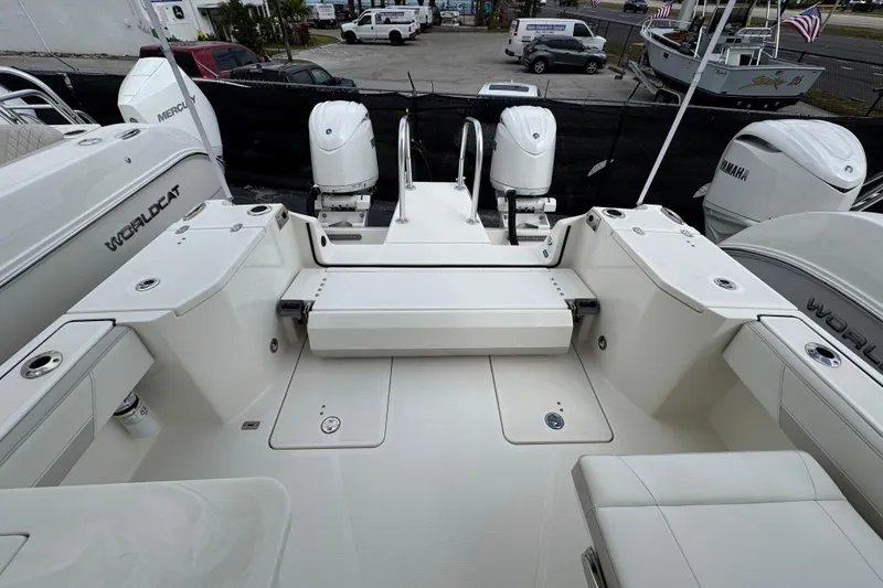 Slide: The Image of 2024 World Cat 260 DC-X boat deck with dual outboard motors, showcasing spacious seating. - 50
