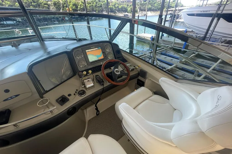 Slide: The Image of Helm of 2006 Sea Ray 44 Sundancer yacht with navigation controls and captains chair with flip-up bolster - 13