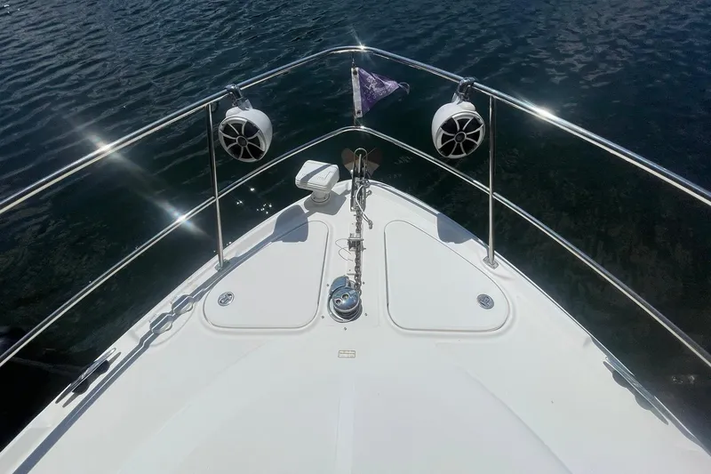 Slide: The Image of Bow of 2006 Sea Ray 44 Sundancer yacht with speakers and anchor, on water. - 60