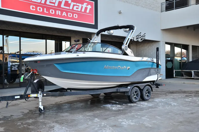 Slide: The Image of 2023 MasterCraft XT22 T boat on trailer outside showroom in Colorado. - 3