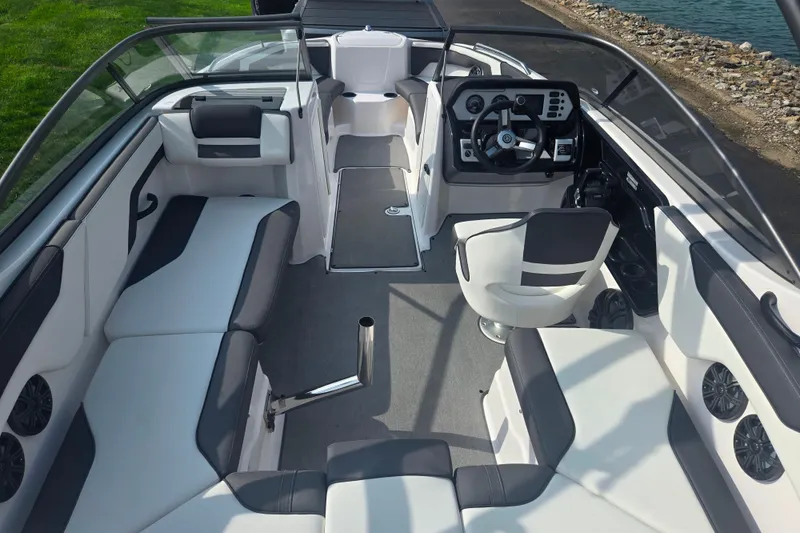 Slide: The Image of 2022 Yamaha Boats AR210 interior with sleek seating and modern dashboard design. - 10