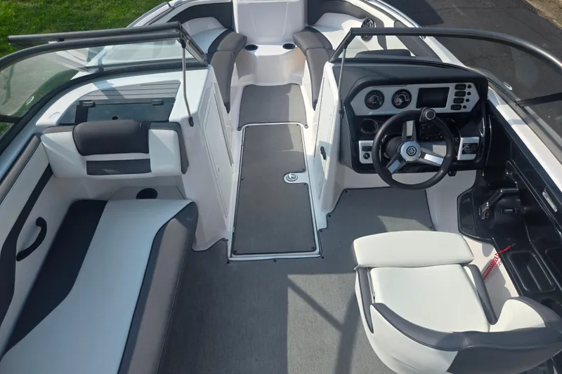 Slide: The Image of 2022 Yamaha Boats AR210 interior with modern dashboard and seating arrangement. - 11