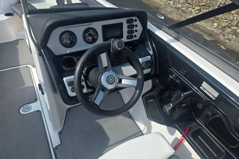 Slide: The Image of 2022 Yamaha Boats AR210 dashboard with steering wheel and control panel. - 12